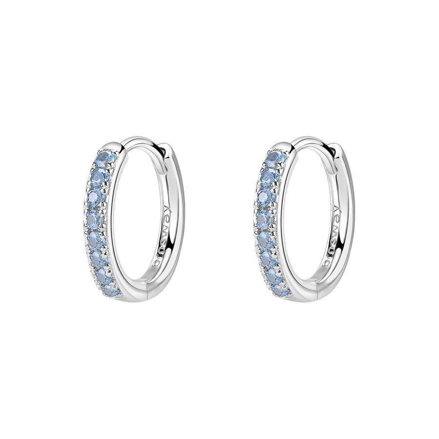 Silver hoop earrings with blue gemstones on a white background