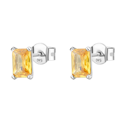 Pair of silver earrings with yellow gemstones on a white background