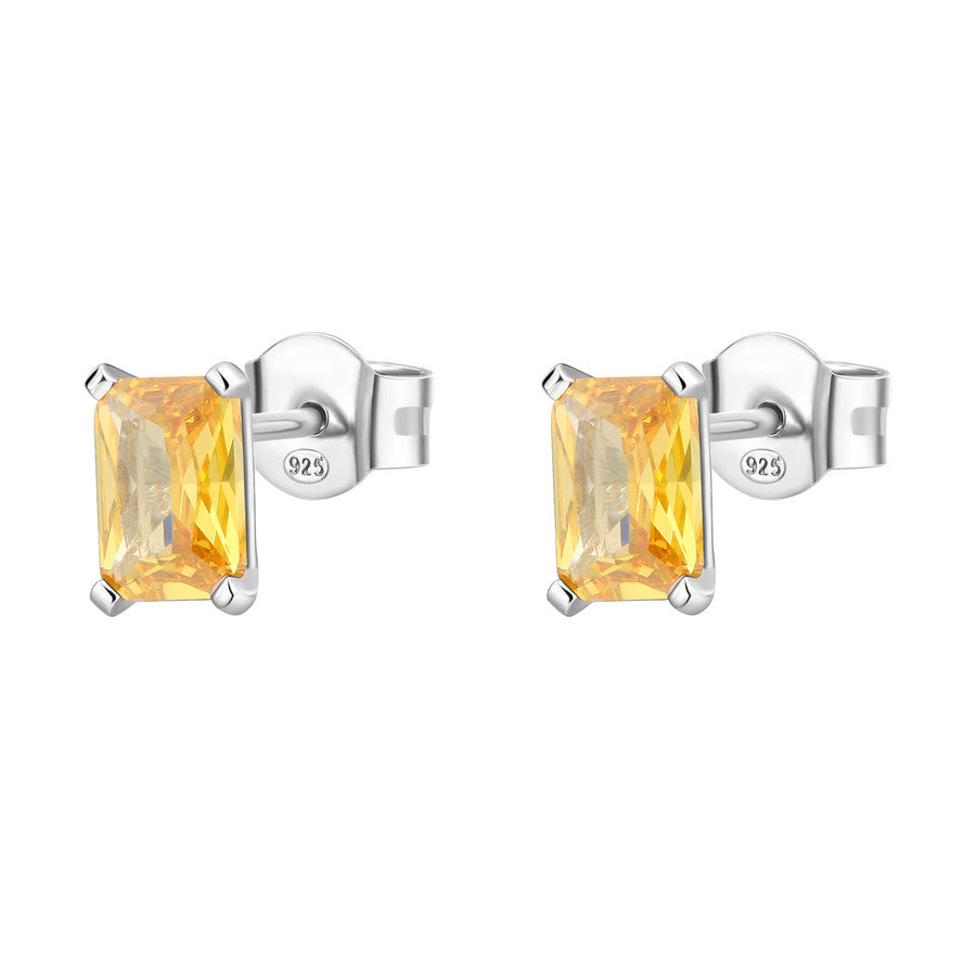 Pair of silver earrings with yellow gemstones on a white background