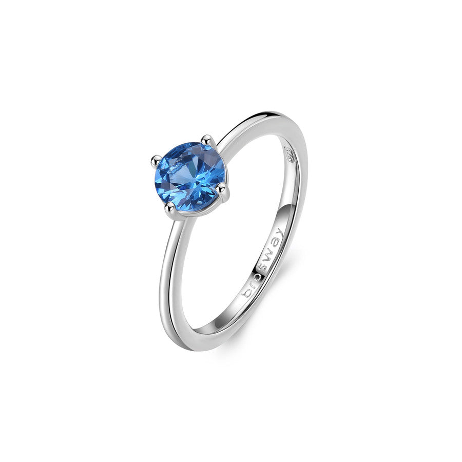 Silver ring with a blue gemstone on a white background
