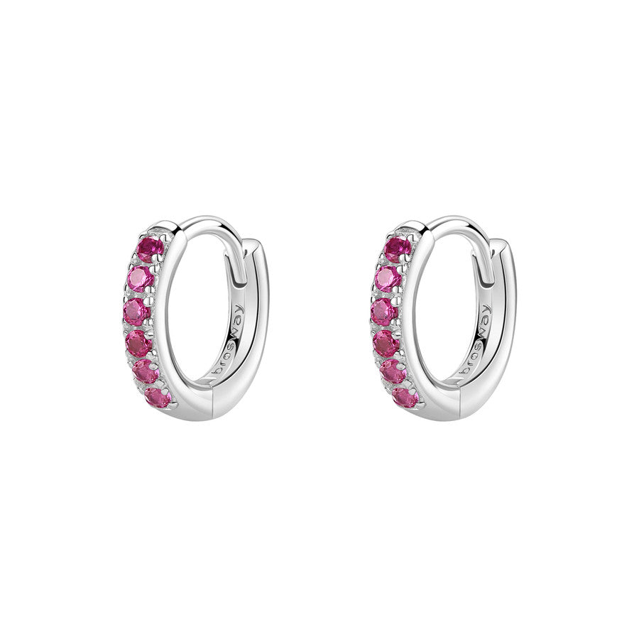 Silver hoop earrings with pink gemstones on a white background