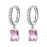 Silver hoop earrings with pink gemstones on a white background