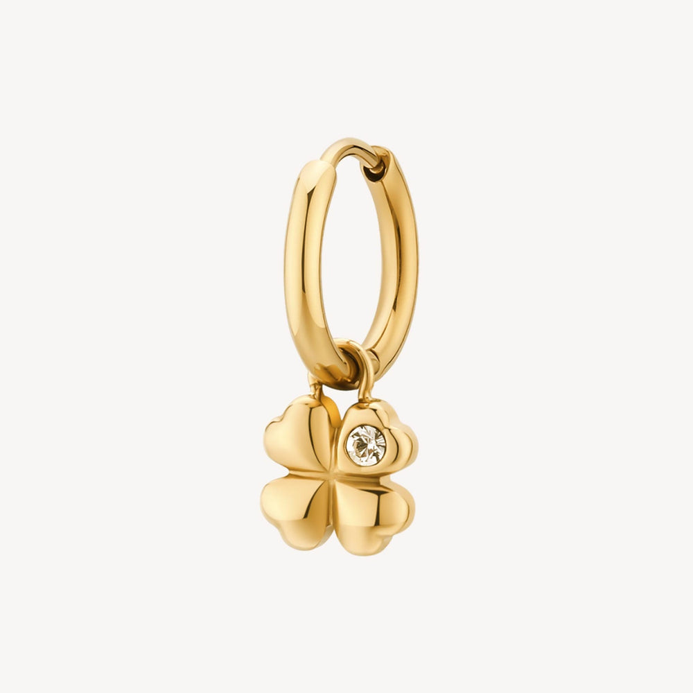 Gold hoop earring with a clover charm on a white background