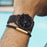 Men's MVMT Voyager Tundra, accented with gold markers, hour, minute and second hands on a balck dial. Dual chronographs with active time keeping features and a date wheel placed at the three o'clock marker. This watch casing sits between a black mesh stainless steel strap perfect for intricate sizing. 