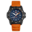 The orange strap, black case, and navy blue striped face create a quirky aesthetic that pairs well with the simplicity of the design. The second and hour numerals and markers are minimalistic and easily readable as well as the bold hands. The magnifier over the day date also attracts attention to that feature. In darkness the hour markers and hands illuminate for maximum visibility.