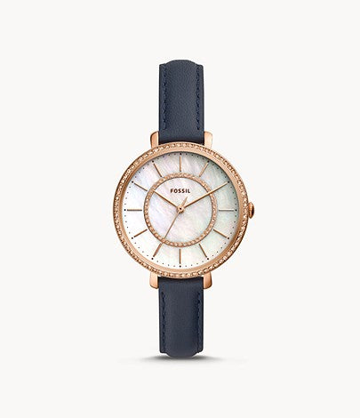 The thin navy blue leather strap draws attention to the ornate face of the watch. The crystal lined bezel is a pale rose gold tone stainless steel that matches the slim hour markers and hands that adorn the opalescent dial.