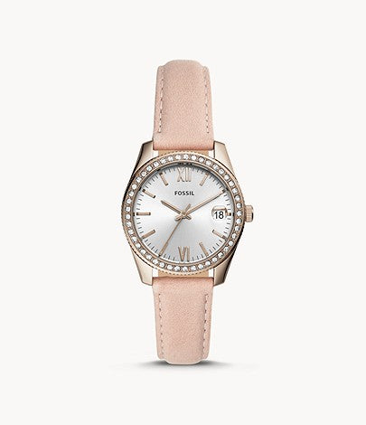 This piece features a slim light pink leather strap and a rose gold tone case and bezel. The crystal lined bezel frames the silver tone face with complimentary rose gold tone hour markers and hands. The day date is displayed at the 3 o'clock mark.