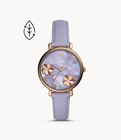 The slim light purple strap attaches to the subtle rose gold bezel that frames the opalescent dial. The dial is adorned with a flowery pattern and slim rose gold hour markers and hands.
