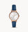 The slim navy blue leather strap compliments the rose gold case and textured bezel. The slight rose gold hour markers and hands are easily visible against the white dial.
