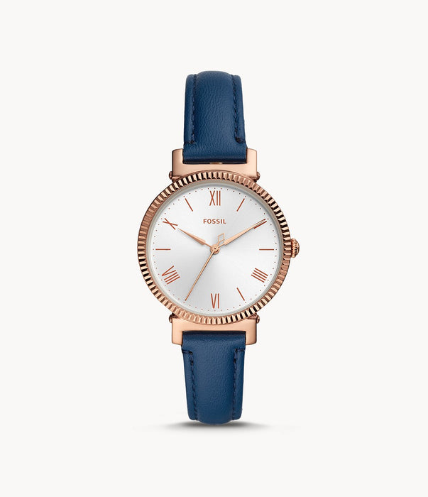 The slim navy blue leather strap compliments the rose gold case and textured bezel. The slight rose gold hour markers and hands are easily visible against the white dial.
