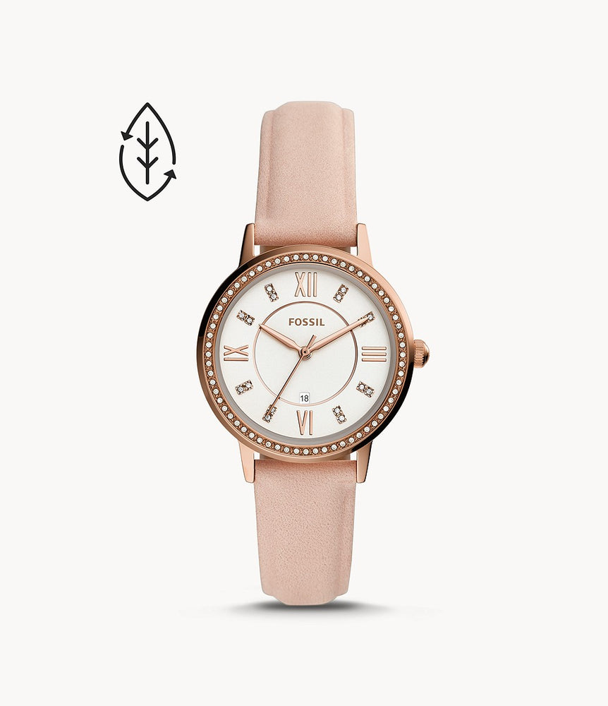 Rose gold-tone stainless steel case with a nude leather strap. Fixed rose gold-tone beel set with crystals. White dial with rose gold-tone hands and crystal hour markers. Roman numerals appear at the 3, 6, 9 and 12 o'clock positions.