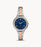 The two tone stainless steel bracelet attaches to the matching case and crystal lined bezel. The flat navy blue face contrasts the light color and allows the gold tone Roman numerals and hands to be easily readable.