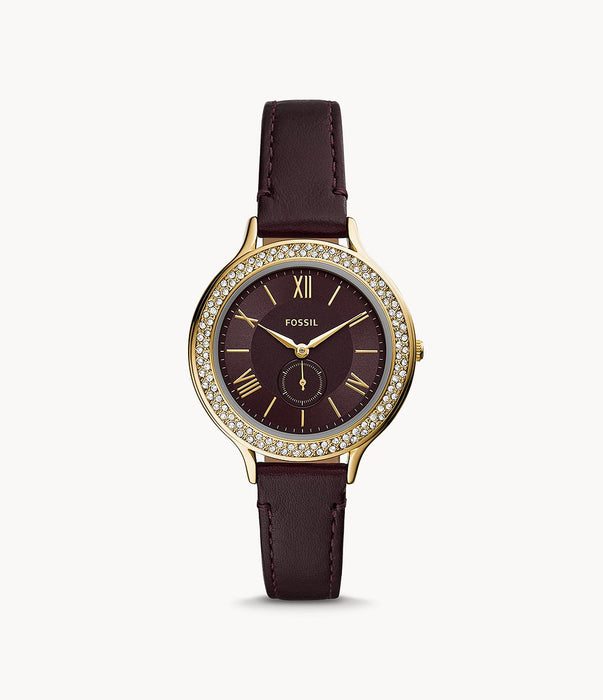 The dark brown leather strap attaches to the complimentary gold tone stainless steel case and crystal lined bezel. The chocolate brown face features slim gold tone Roman numerals and hands as well as a matching sub dial.