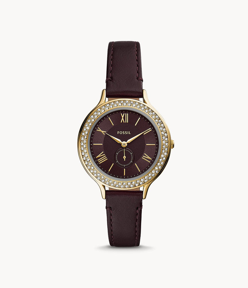The dark brown leather strap attaches to the complimentary gold tone stainless steel case and crystal lined bezel. The chocolate brown face features slim gold tone Roman numerals and hands as well as a matching sub dial.