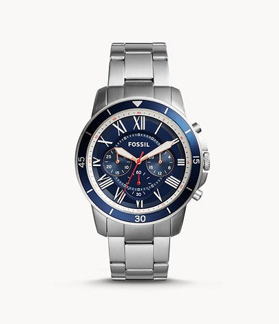 The silver tone stainless steel bracelet attaches to the stainless steel case that is also silver tone with a navy blue dial outside of the face. The face is also a metallic navy blue with whitie Roman numerals at each hour and 3 subtle subdials. The white hands match the numerals and provide the contrast necessary for easy readability.