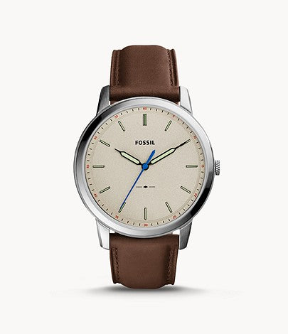 The name of this watch truly captures its design- minimalist. The brown leather strap attaches to the silver case that frames the beige face with slight hour markers and luminescent hands.