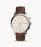 The smooth brown leather strap attaches to the silver tone stainless steel case and bezel that frames the perfectly round beige face. The color scheme is vintage with a touch of modern while the background is beige and the accents are silver.