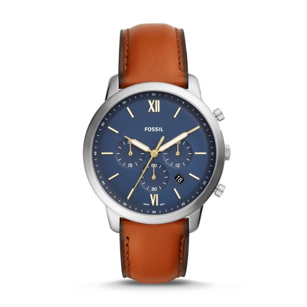 This watch features a reddish brown smooth leather strap with burnt edges that attaches to a modern, clean stainless steel case with a matte blue face. The juxtaposition of the two aesthetics draws attention and creates versatility for the piece. The gold and white accents on the face are easily visible.