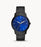 This piece features a flat black metal band that attaches to the thin black bezel. This frames the bold blue face of the watch with white hour markers and hands.