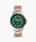 Stainless steel case with a two-tone (silver-tone and rose gold-tone) stainless steel bracelet. Fixed rose gold-tone bezel with an inlaid green ring. Green dial with luminous rose gold-tone hands and dot hour markers. Minute markers around the outer rim. Dial Type: Analog. Luminescent hands and markers. Date display at the 3 o'clock position.