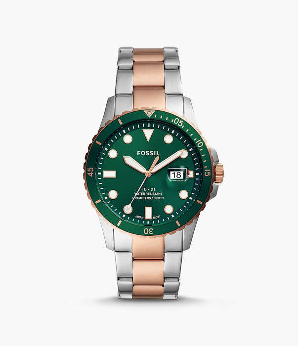 Stainless steel case with a two-tone (silver-tone and rose gold-tone) stainless steel bracelet. Fixed rose gold-tone bezel with an inlaid green ring. Green dial with luminous rose gold-tone hands and dot hour markers. Minute markers around the outer rim. Dial Type: Analog. Luminescent hands and markers. Date display at the 3 o'clock position.