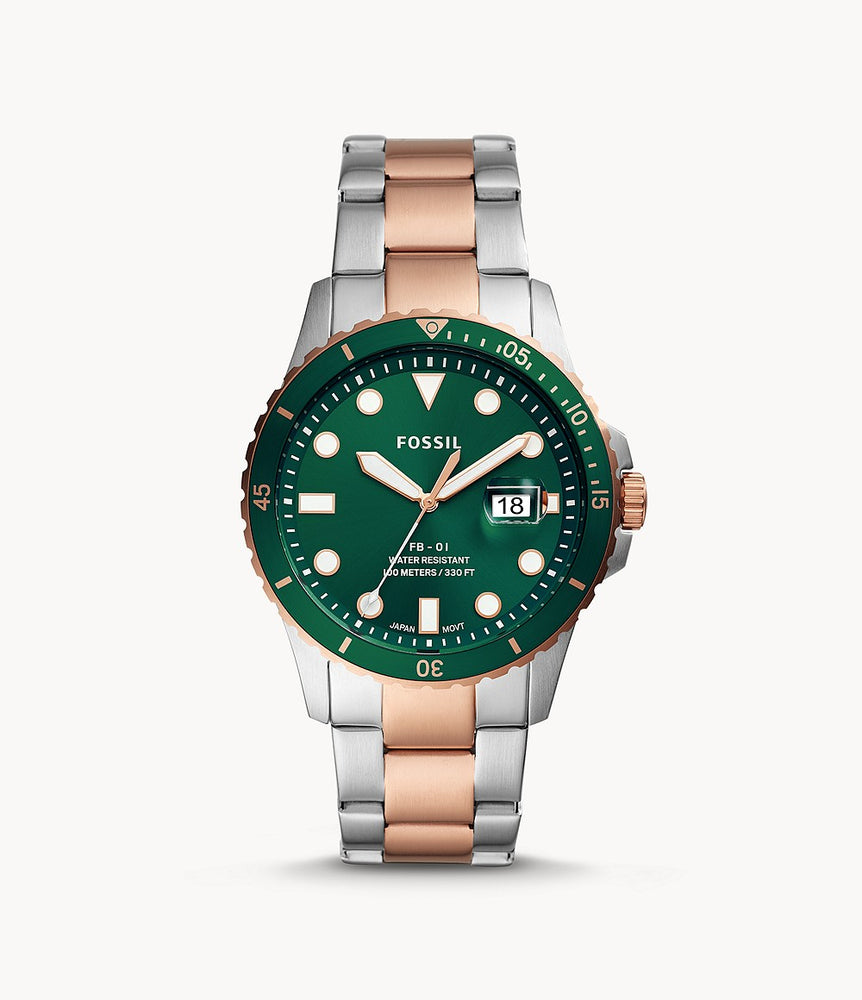 Stainless steel case with a two-tone (silver-tone and rose gold-tone) stainless steel bracelet. Fixed rose gold-tone bezel with an inlaid green ring. Green dial with luminous rose gold-tone hands and dot hour markers. Minute markers around the outer rim. Dial Type: Analog. Luminescent hands and markers. Date display at the 3 o'clock position.